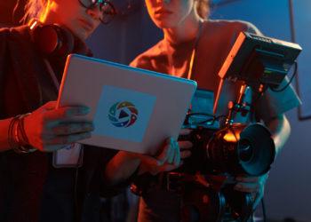 Cropped shot of video production crew discussing images on digital tablet screen copy space